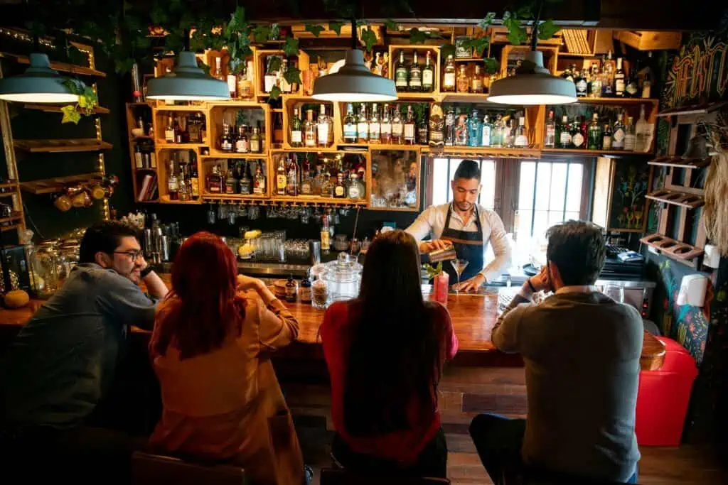Latin American bartender at the bar making cocktails