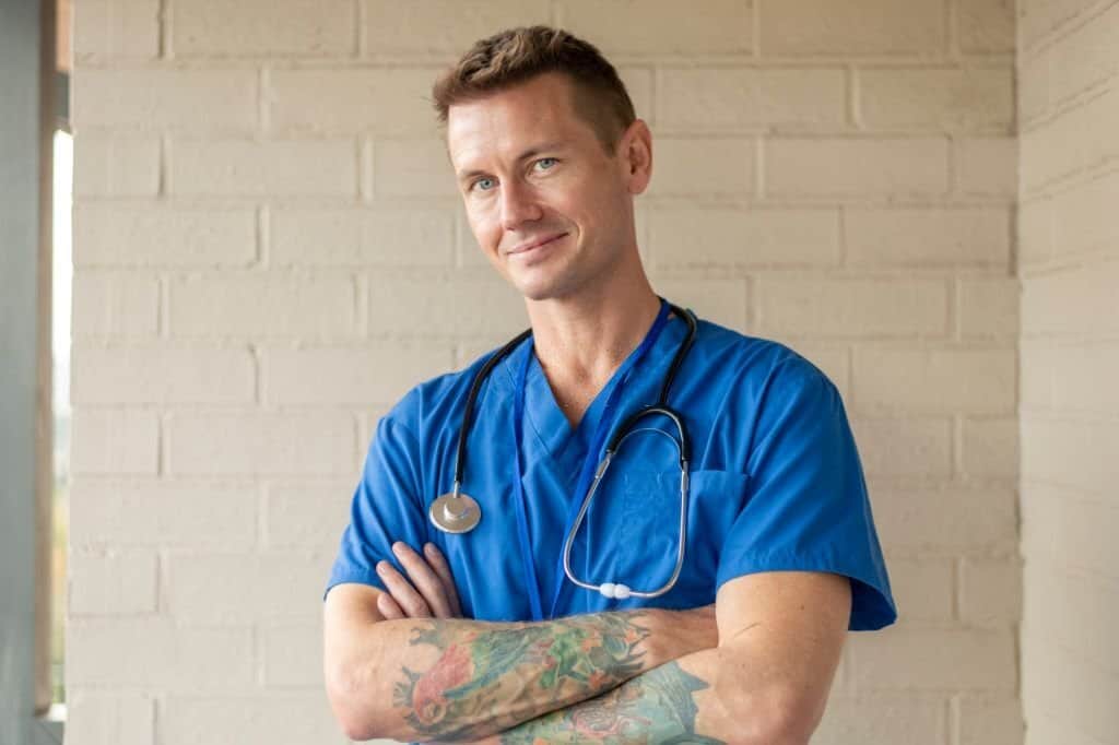 Male doctor with tatoo