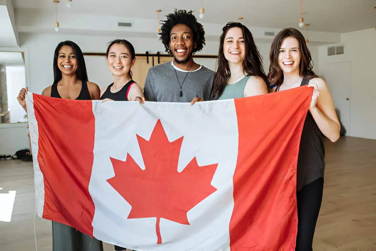 college students holding a Canadian flag